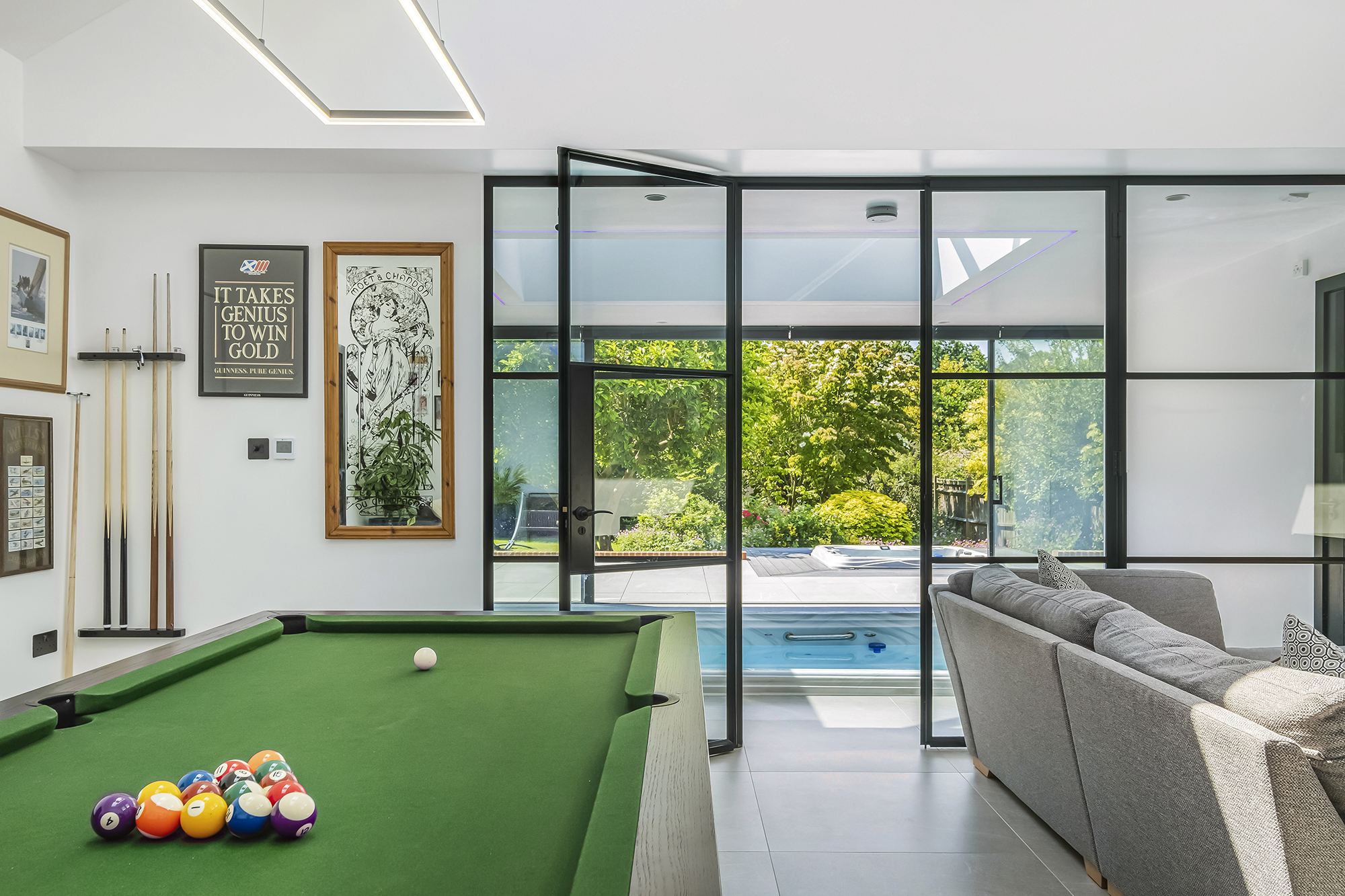 Finished extension West Sussex pool table looking through doors at swim spa and jacuzzi
